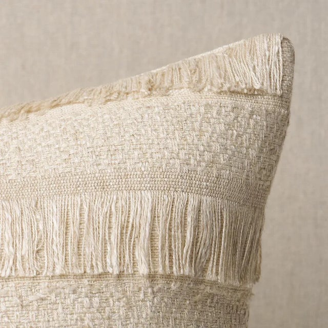 This pillow features Acadia with a knife edge finish. A horizontal fringed stripe, this pattern derives from a textile in...