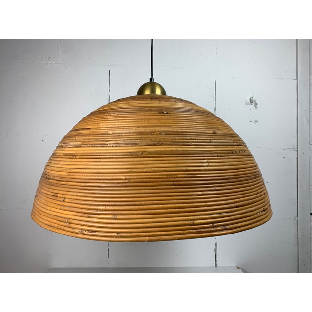 A wonderful and exceptional rare extra large brown pencil or split reed rattan wicker bamboo pendant lamp with brass,...