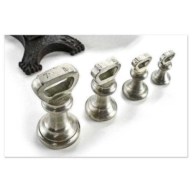 Antique precision balance on a stand, composed of a cast iron and brass structure with a finely openwork central beam. It...