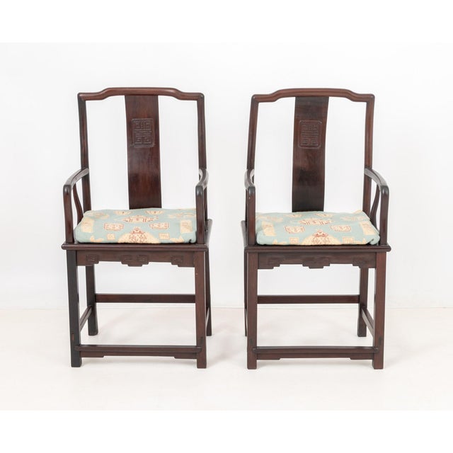 Pair of Chinese Hongmu Arm Chairs, with teapot and vessel motif needlepoint cushions. 42" H x 21.75" W x 17.5" D; seat:...