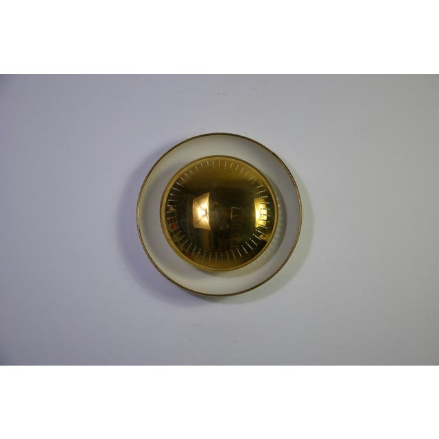 This striking midcentury brass flushmount or wall lamp by hillebrand leuchten, crafted in the 1960s, is a sophisticated...