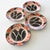 Wonderfully graphic wall plates with stencilled and hand painted design in orange, black and gold commemorating the...
