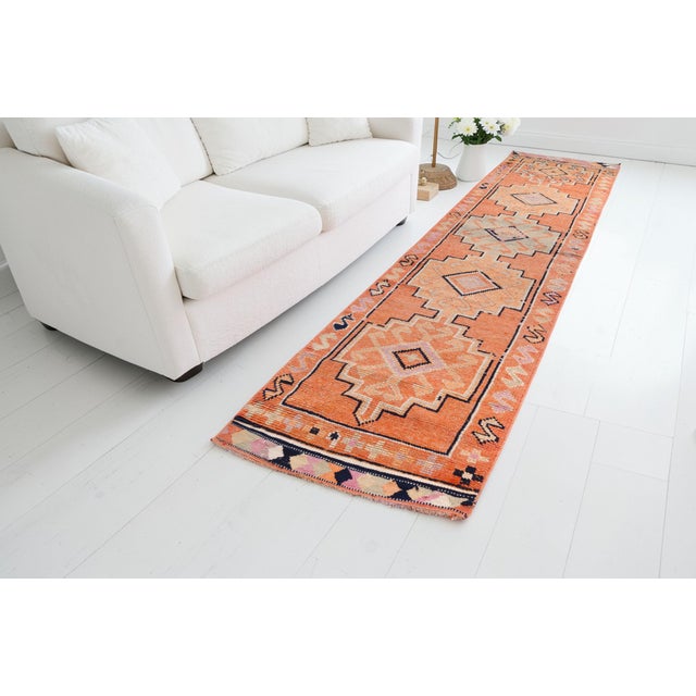This is a vintage Turkish Oushak rug from the Mid 20th Century. The piece was hand-knotted.