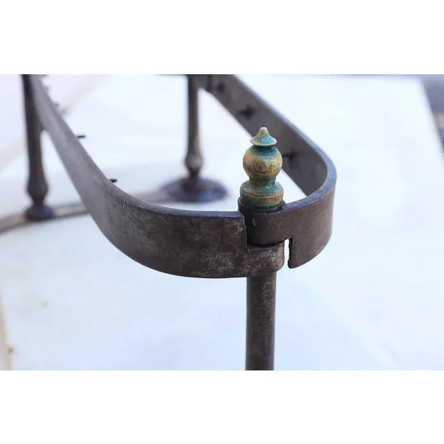 A very old and hard to find porte-jambon of iron with brass handles on a marble slab. The handles have an adjustable jaw...