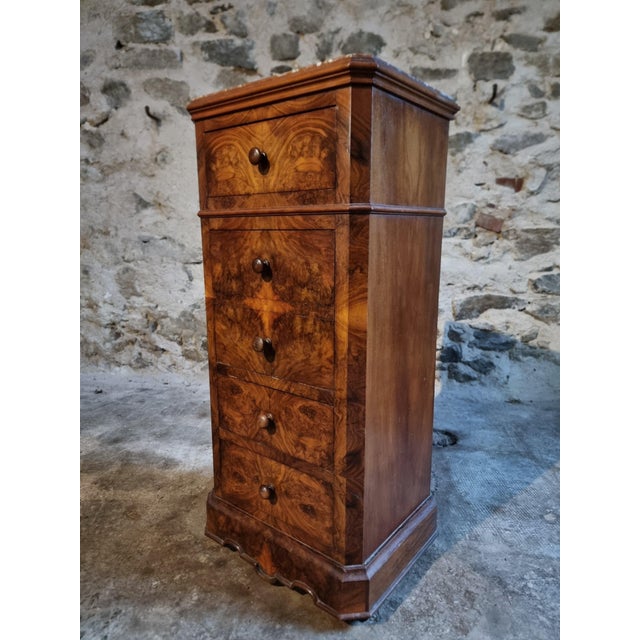This antique French bedside cabinet dates from around 1900 and is made from oak with burr walnut veneer. The piece...