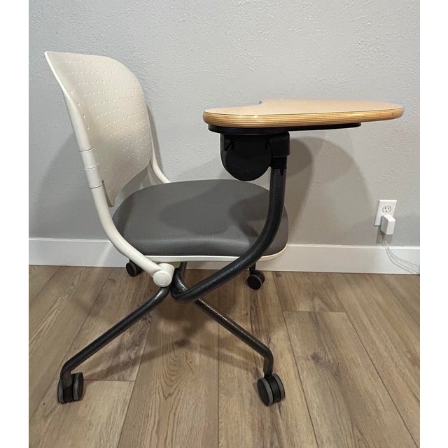 A sleek and functional tablet arm chair from Krueger International (KI). Features: - Wood tablet arm that can be moved up...