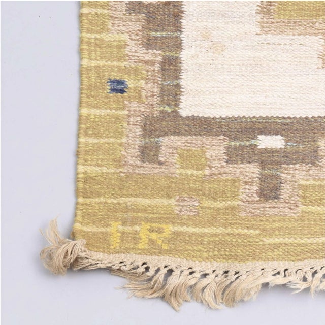 A lovely mid 20th century Swedish flat weave rug. It has three stylised elongated geometric shapes in yellow and blue set...