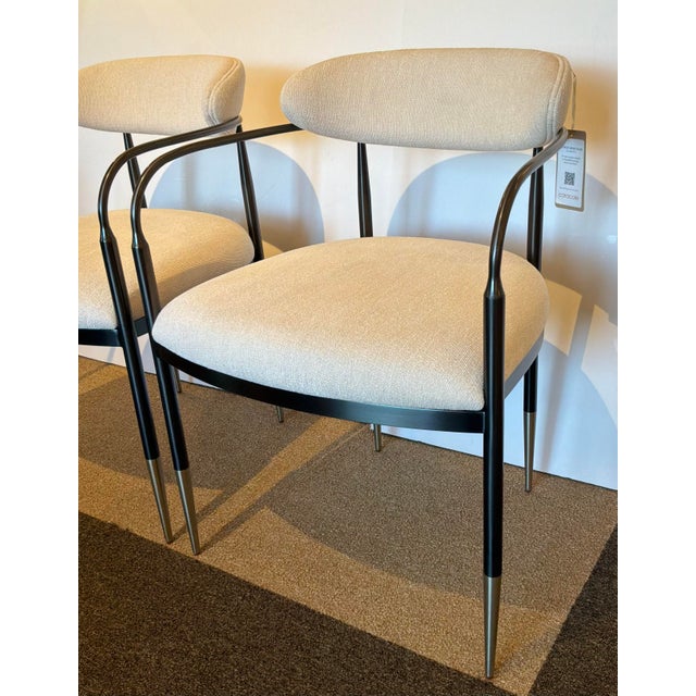 Original retail $5150, stylish Caracole Modern Epoch Armchairs Pair, deep bronze frame with champagne gold ferrules, cream...