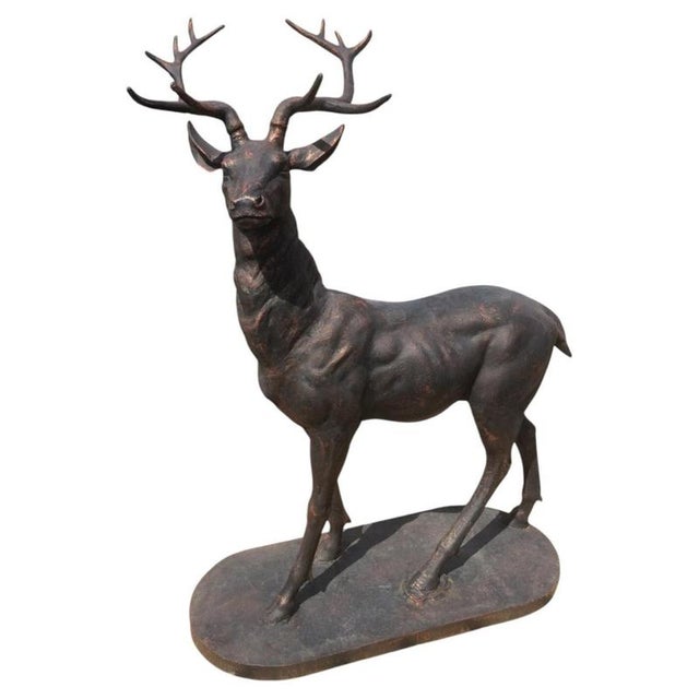 An impressive pair of life-size cast iron stag sculptures, modelled as complementary left- and right-facing figures to...