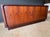 Rare Danish modern rosewood tambour door credenza with center dovetailed drawer section and adjustable shelf on each side.