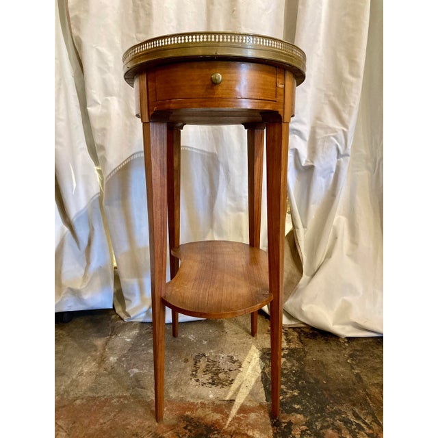 perfect for any space, this mahogany table sports a marble top and a brass gallery to protect again those spills that...