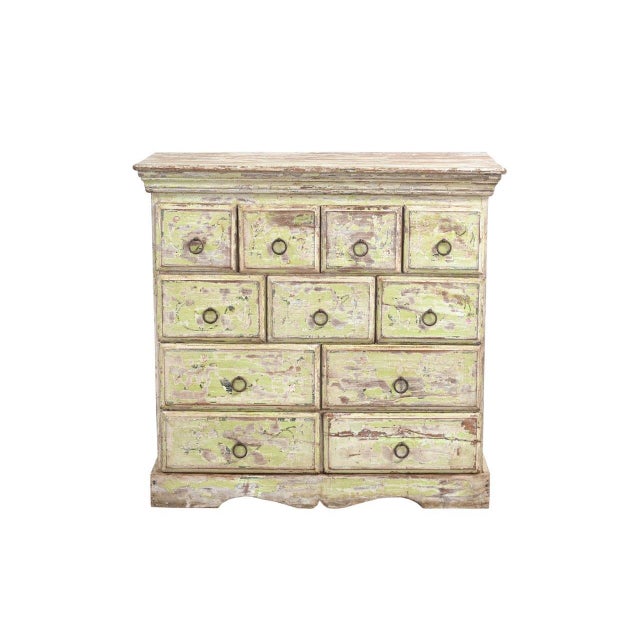 This Vintage Indian Painted Multi-Drawer Chest is a charming storage piece featuring an array of drawers in varying sizes...