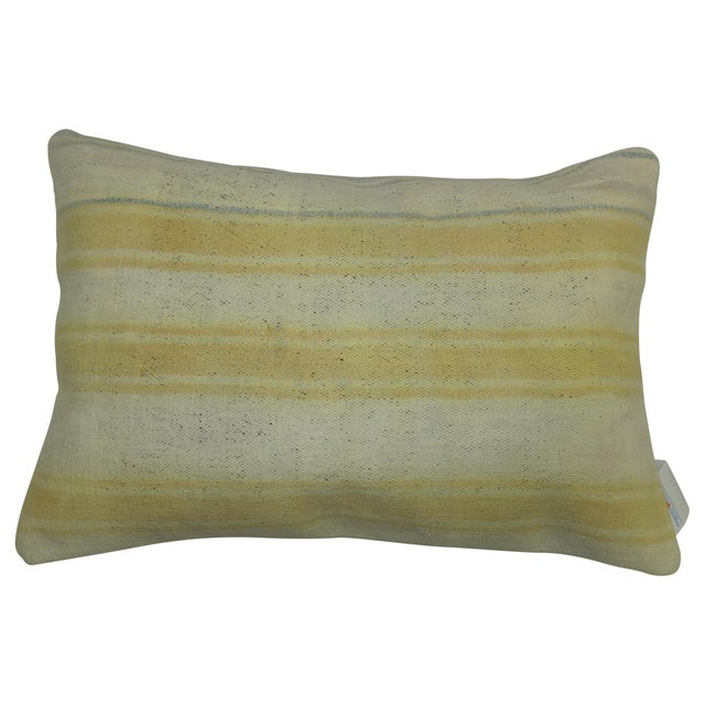 Pillow made from a vintage Indian Dhurrie flat-weave in white and soft yellow Measures: 16" x 23".