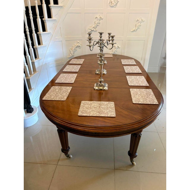 A handsome antique mahogany wind out dining table with a lovely rich colour and well figured top. The table is raised on...
