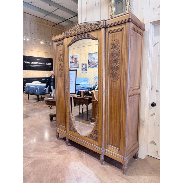 This is a striking vintage carved wood armoire designed with rich traditional character and refined craftsmanship. The...