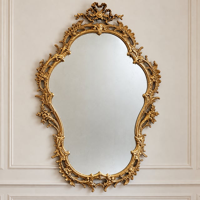 This elegant French Baroque style wall mirror features a richly detailed gold leaf frame with beautifully hand-carved...