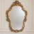 This elegant French Baroque style wall mirror features a richly detailed gold leaf frame with beautifully hand-carved...