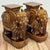 Vintage rich brown glazed elephant garden stools featuring decorative garb with tasseled headdress and saddle draping....