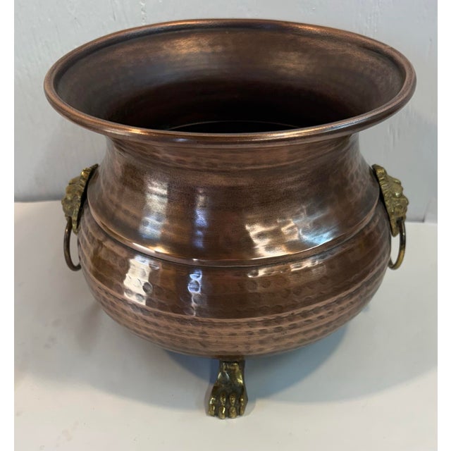 Nice vintage hammered copper cauldron shaped planter with lion masks and rings on each side.
