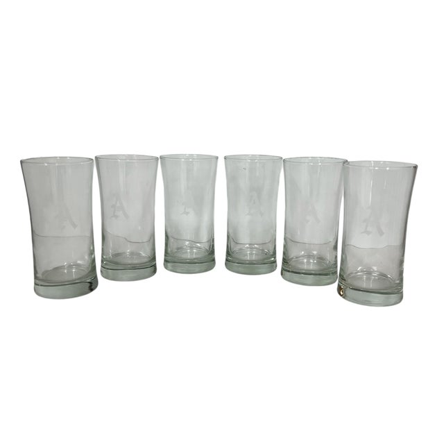 Set of six vintage etched monogrammed “A” water glasses. Glass is wavy and appears to be blown. Each measures 3” diameter...