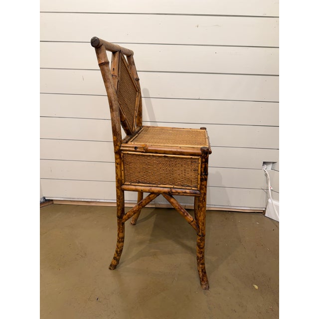 This is a unique English faux-bamboo side chair with seat storage. It is sturdy for anyone needing extra seating and...