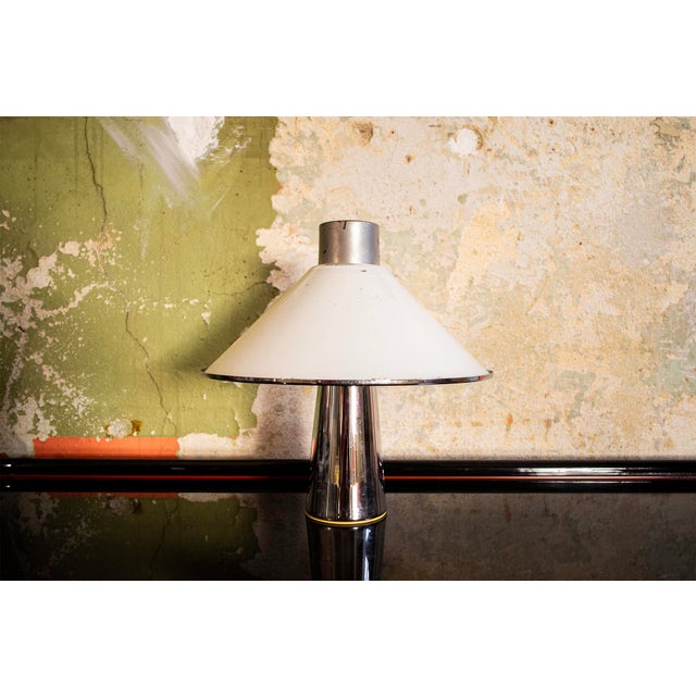 Table lamp with chromed metal frame and acrylic shade. Designer attributed to Harvey Guzzini 1960s This piece is...