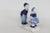 This charming Miniature Figurine is made of porcelain. This adorable piece features a young boy and girl in Dutch style...