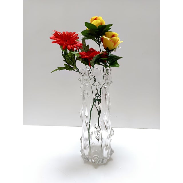 Made in Italy, 1940. This is a vase attributable to the "A Mugnoni" series in transparent heavy blown glass, decorated...