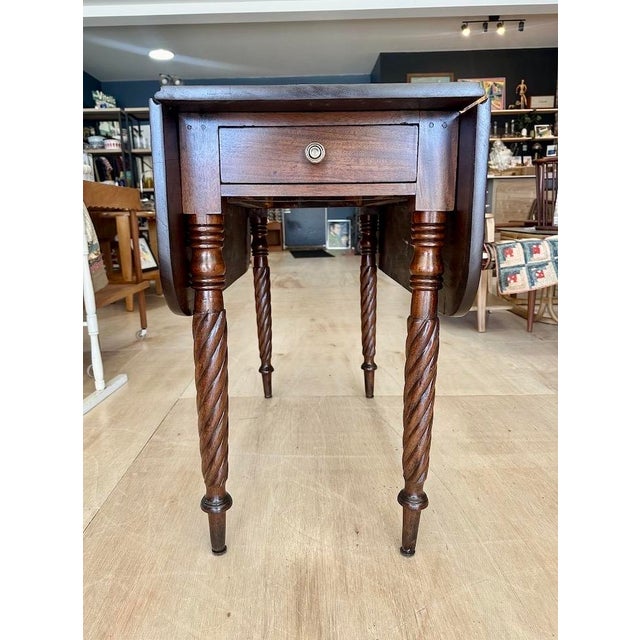 Mahogany Pembroke Table from the early to mid 1800’s. Features solid mahogany top with pair of drop leaves, single drawer...