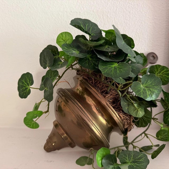 This vintage brass decorative wall scone and candle holder is a charming addition to any home decor. Crafted from brass,...