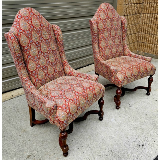 Featured is a tall, slender and stately pair of custom made William and Mary Style Wingback Chairs with shapely frames...