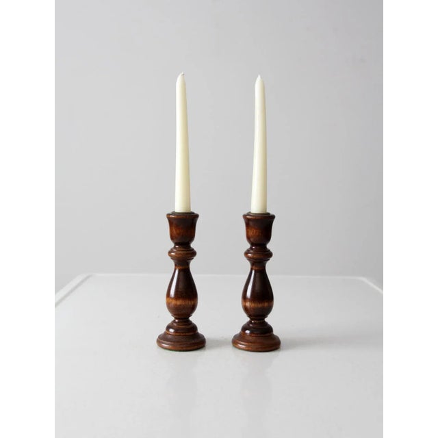 This is a pair of vintage candlestick holders. The turned wood candle holders feature brass candle sockets. Green felt...