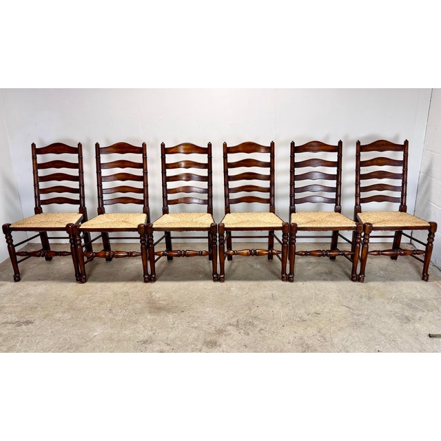 A fabulous set of six Theodore Alexander dining chairs with dark auburn brown finish and rush seats. From the Castle...