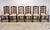 A fabulous set of six Theodore Alexander dining chairs with dark auburn brown finish and rush seats. From the Castle...