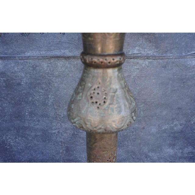 Egyptian Revival floor lamp, circa 1920s, crafted from brass and copper with intricate repoussé and pierced detailing...
