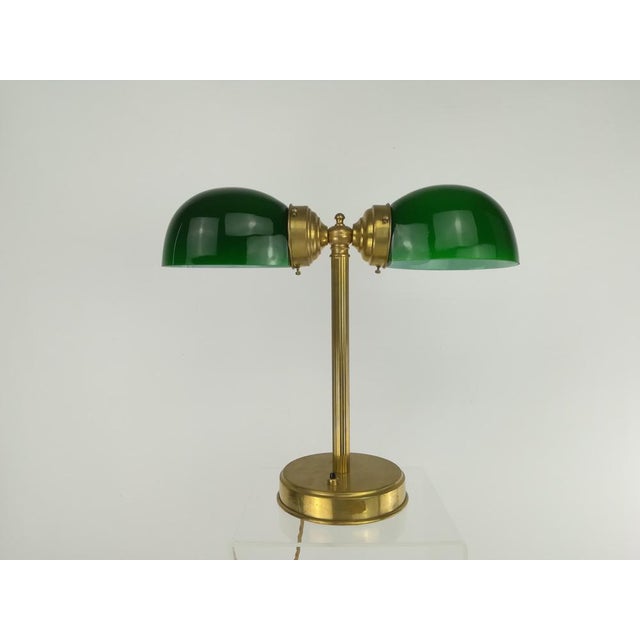 Rare lamp for reading corner or as a cozy light dispenser. Brass polished, two-layer glass on the outside green inside....