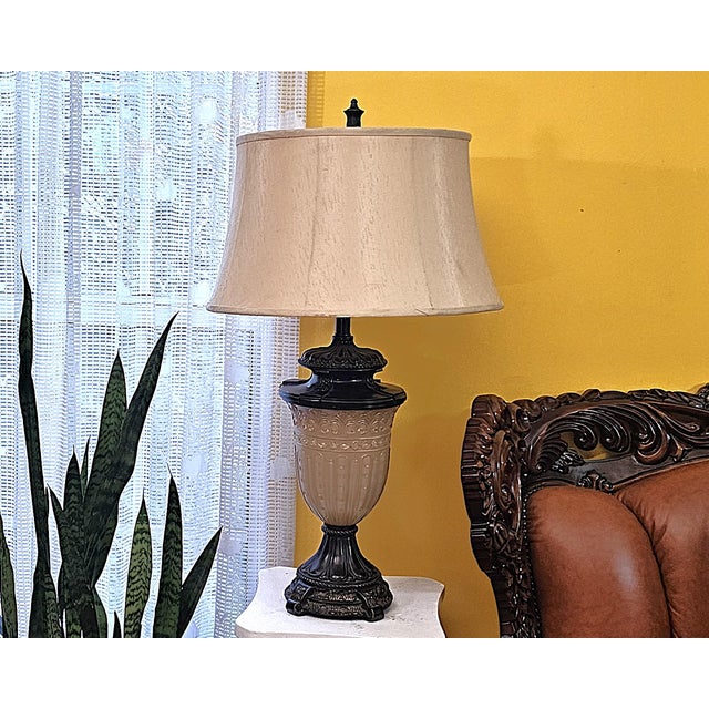 Bring timeless elegance to your home with this vintage Neoclassical-style urn table lamp, featuring a beautifully frosted...