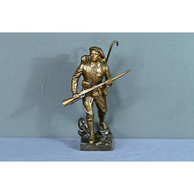 The bronze sculpture with a bronze patina, created by Émile Carlier (1849-1927), offers a striking tribute to the Alpine...