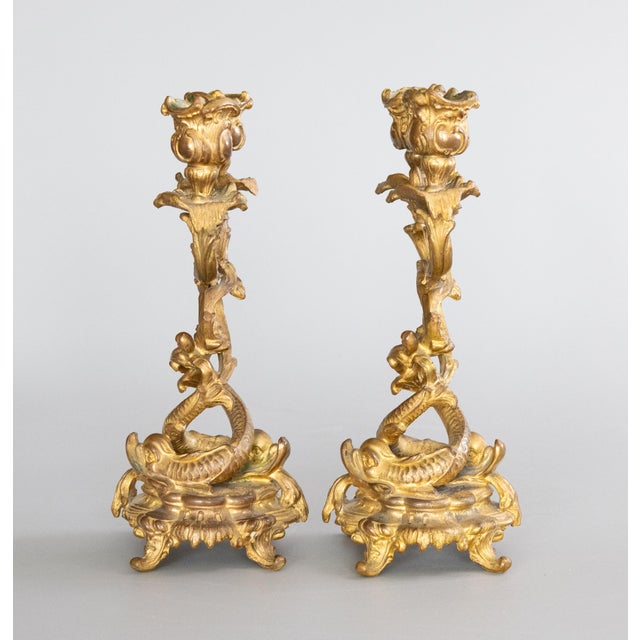 A superb pair of antique 19th Century French gilded bronze ormolu two arm candelabras. The decoration of the candelabras...
