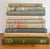 Cozy set of 9 bedside books, in colors which conjure the romantic image of a gray day by the sea. The Old Gringo by Carlos...