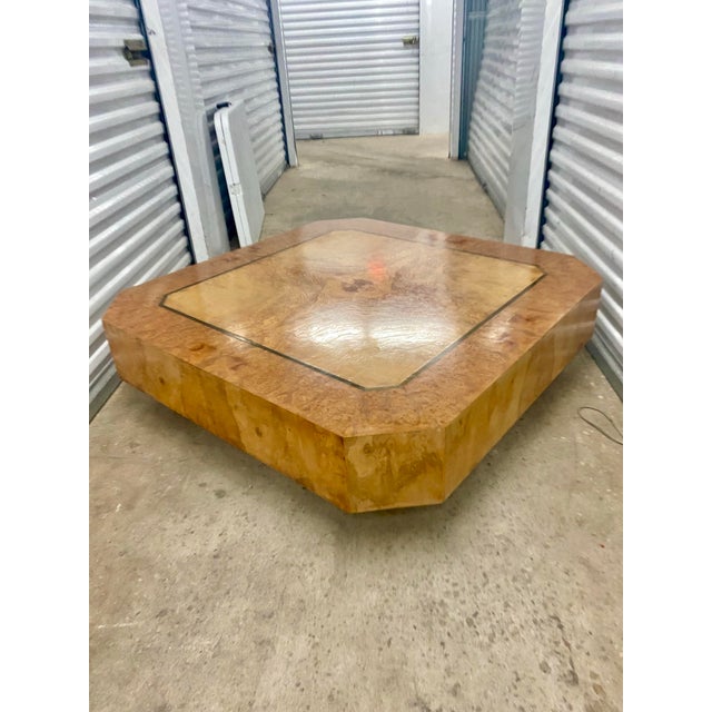 Vintage burl wood coffee table with an inlaid design. Tables with this specific octagonal, low-profile silhouette were...