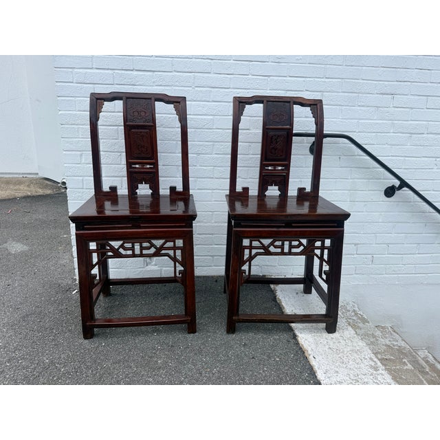 Pair of Chinoiserie Style Carved Wood Hall Chairs. they feature carved back splats and a decorative base. Solid slab seat...