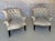 A magnificent pair of small scale French 19th century Napoleon III style armchairs with elegantly scrolled backs and arms...