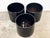 A set three of Gainey black-glazed ceramic planters. Drainage holes were added to ensure plant growth. The planters are in...