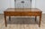 A French walnut desk from the 19th century with carved apron and lateral drawer. This elegant French walnut desk from the...