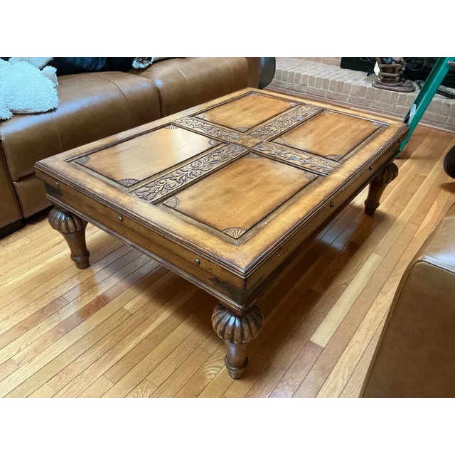 Warm and sculptural, this vintage Indonesian coffee table features a raised cross design with intricate hand-carved floral...