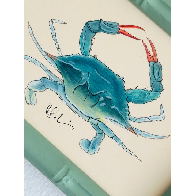 Hand-painted by our master artists, this whimsical crab is brought to life in glowing shades of teal, aqua, and soft sea...