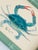 Hand-painted by our master artists, this whimsical crab is brought to life in glowing shades of teal, aqua, and soft sea...