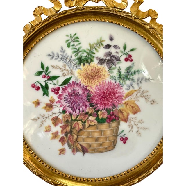 Charming small round gilt bronze frame in the Louis XVI style with floral painting on Limoges porcelain. Excellent...