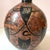 A stunning handcrafted mid-century studio pottery vase featuring a rounded shape and intricate black etched designs over a...